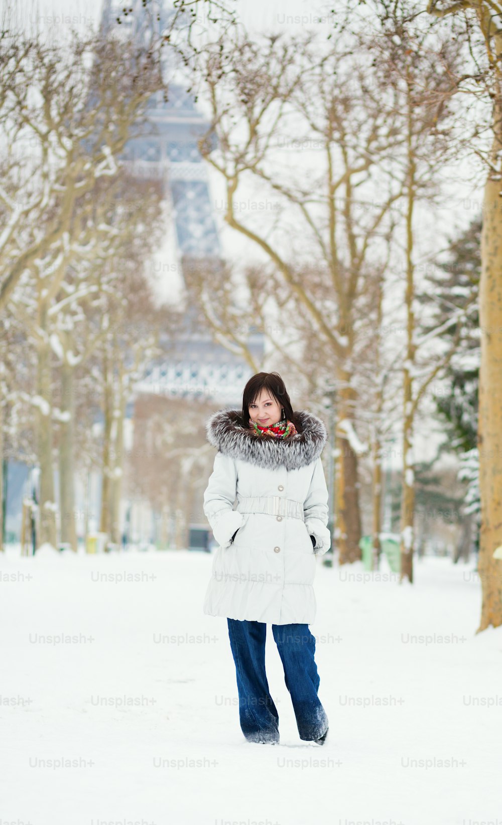 Beautiful young woman in Paris on a snowy day
