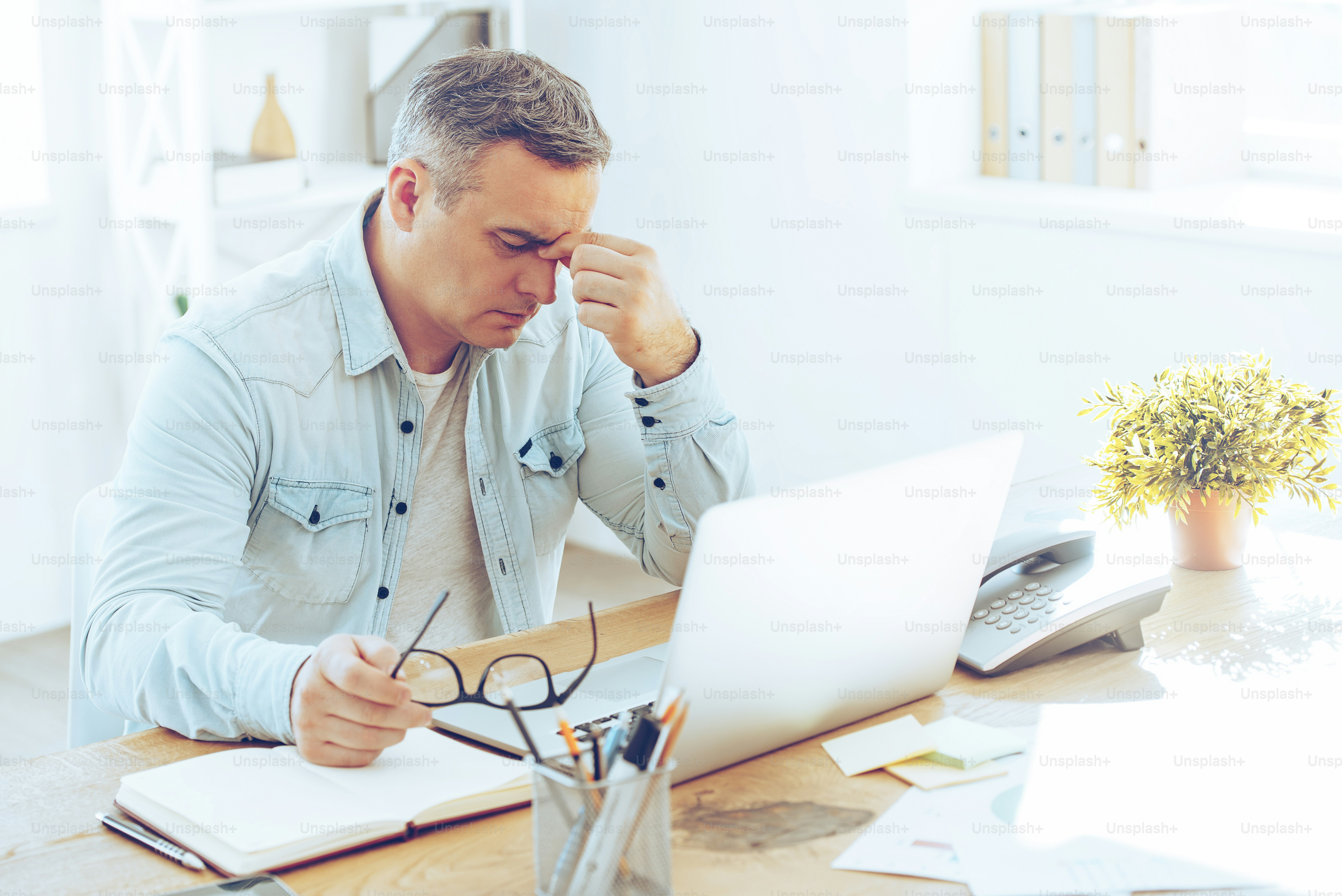 Stressed professional looking at laptop