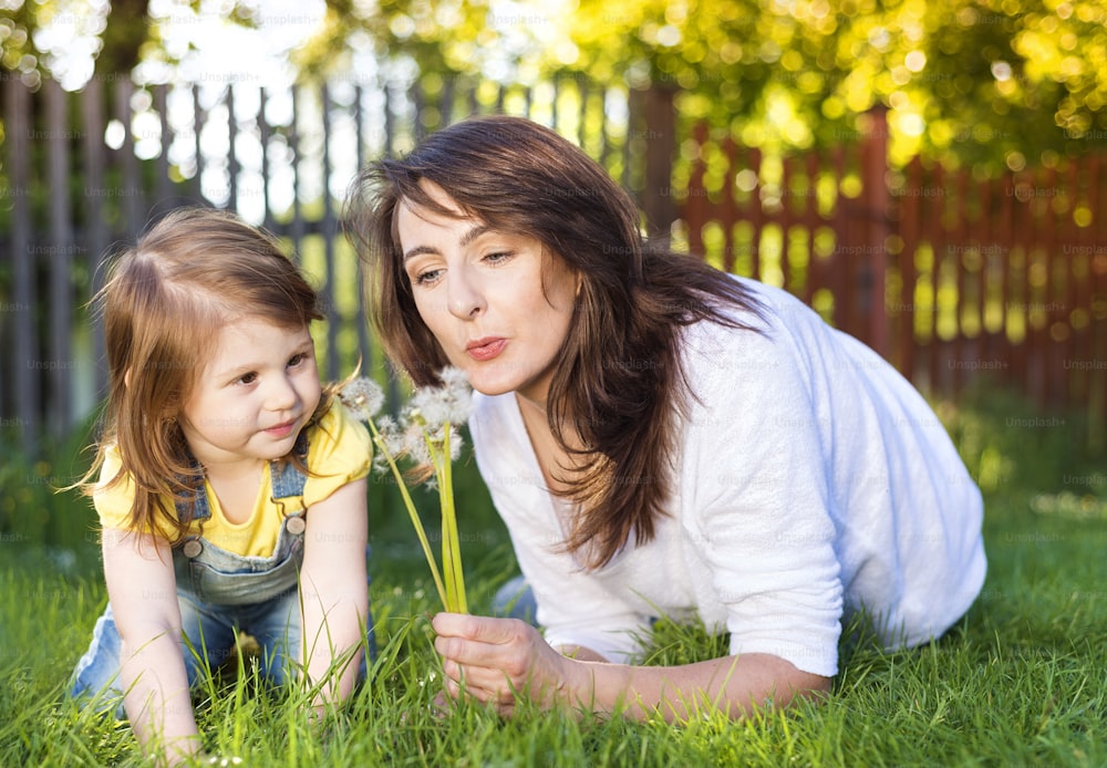 Happy mother and daughter outside in green nature