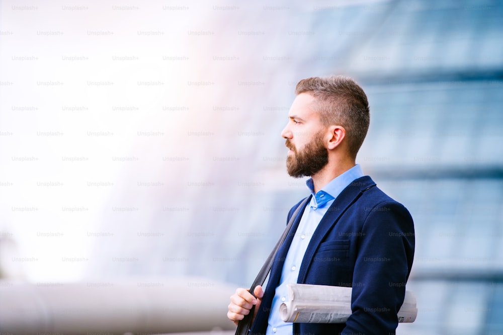 A handsome hipster young man with formal suit sitting on a stool on an  indoor party, looking away. photo – Sitting Image on Unsplash