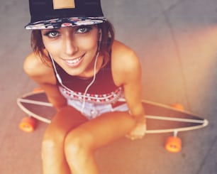 Fashion lifestyle, beautiful young woman with longboard. Lightleak effect and instagram filter