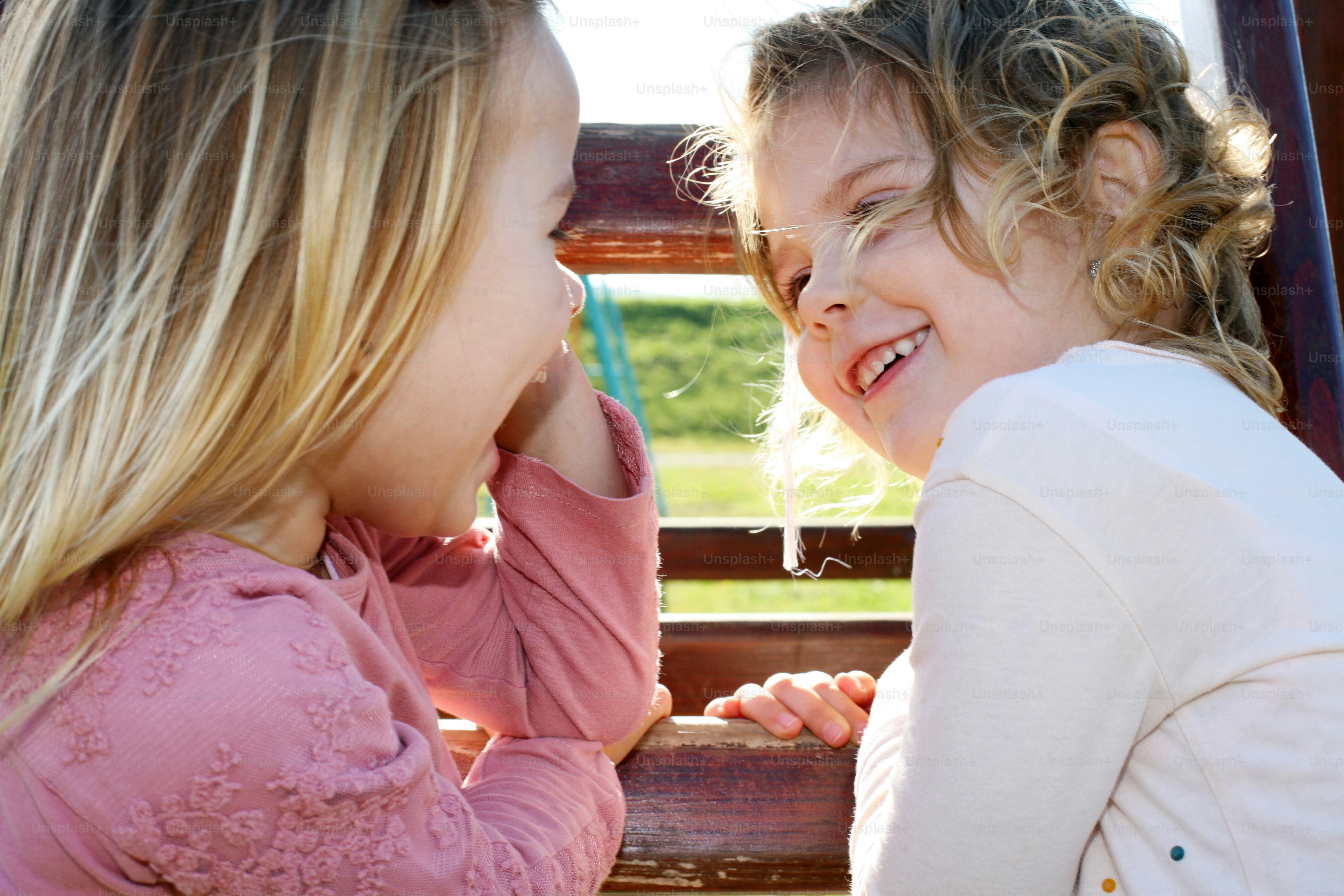 Two little female friends having fun outdoor.