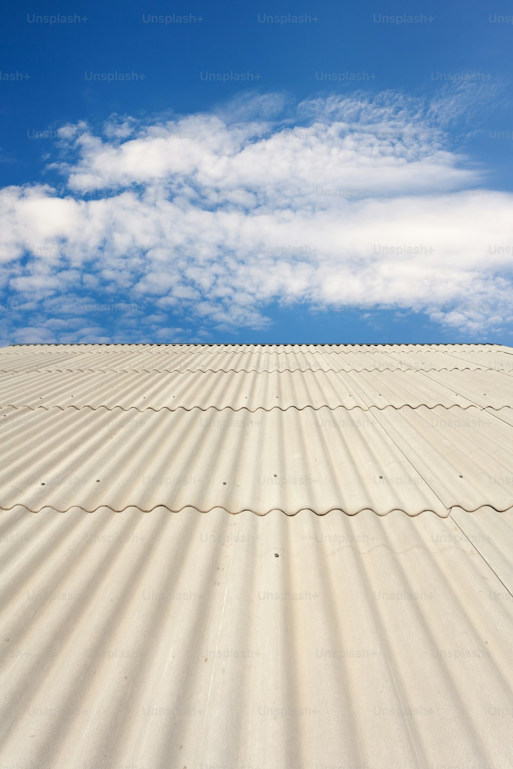 Asbestos slate roof against blue sky