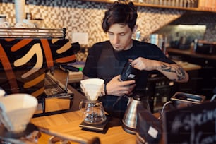 Barista at work in a coffee shop. Preparation service concept