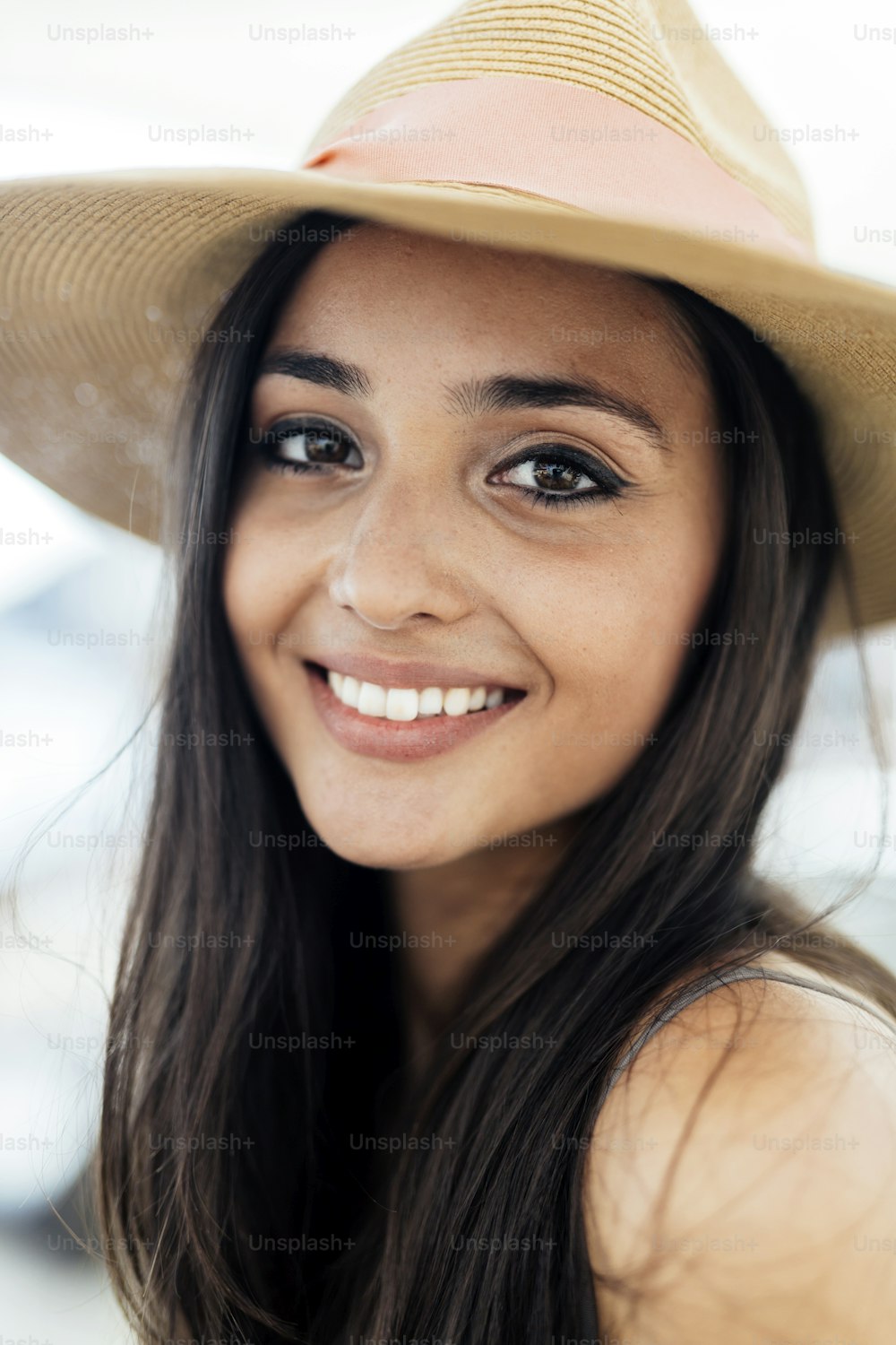 Woman in hat smiling and being truly happy