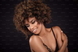 Closeup beauty portrait of young african american girl with afro and glamour makeup.