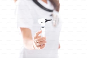 The doctor is holding the Otoscope. Otoscope, close-up