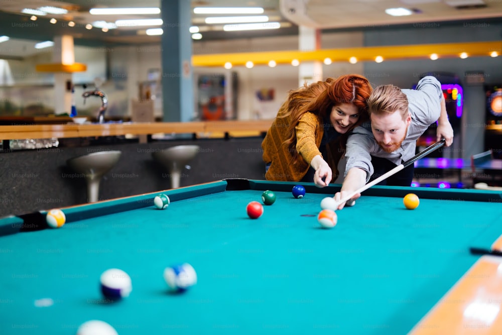 Couple playing billiards and bonding