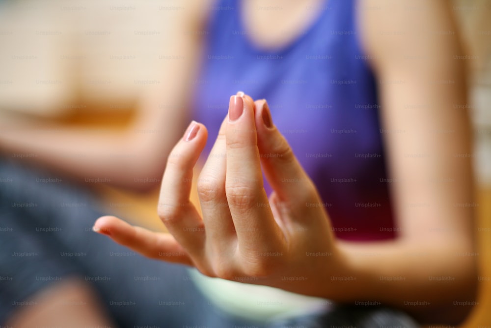 Woman meditating at home, practicing yoga.