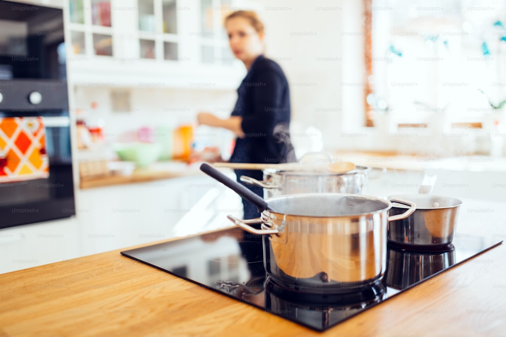 Housewife making lunch in modern kitchen