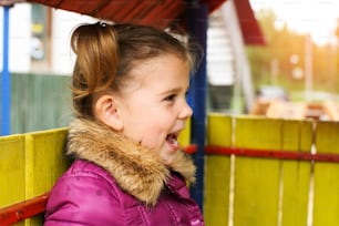 Cute little girl on playground. Space for copy.