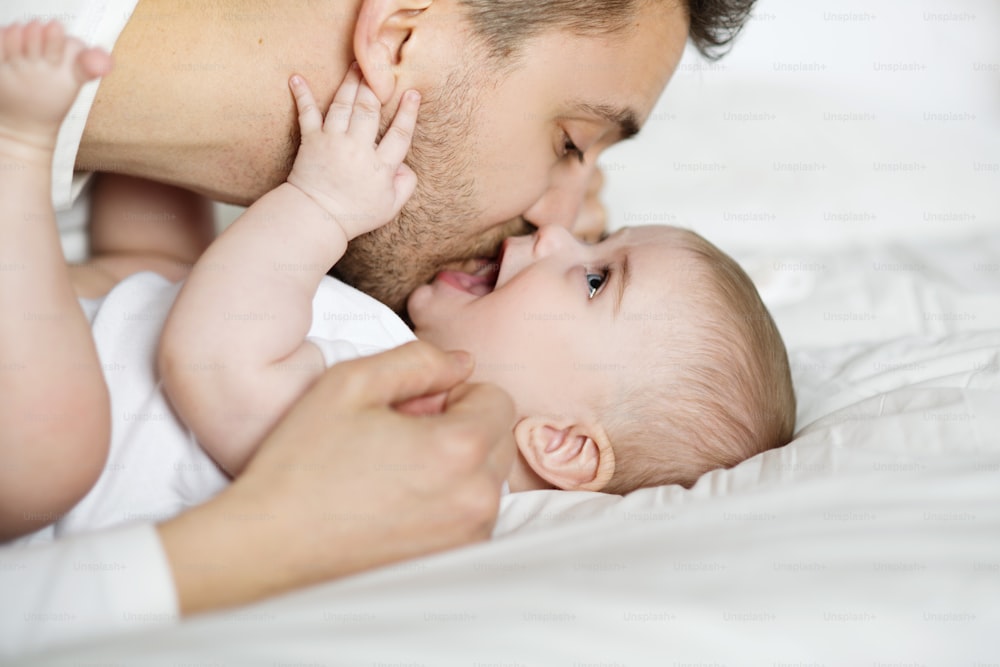 young father is playing with his baby