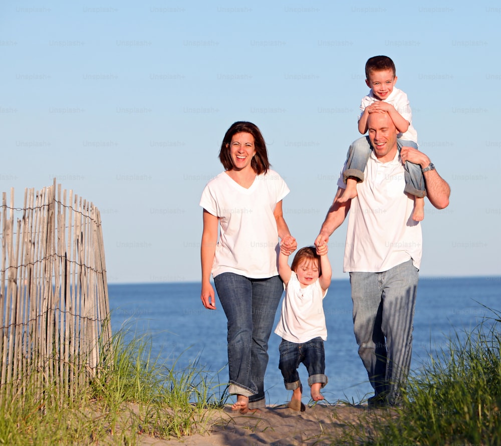 a man, woman, and child are standing on a beach