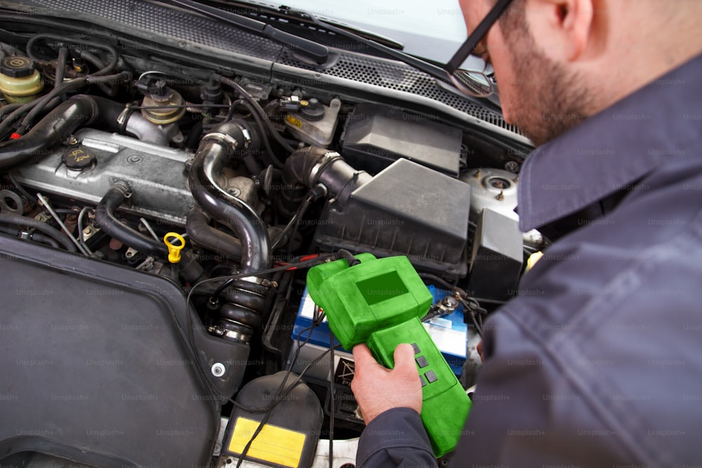 Auto mechanic testing the electrical system on automobile