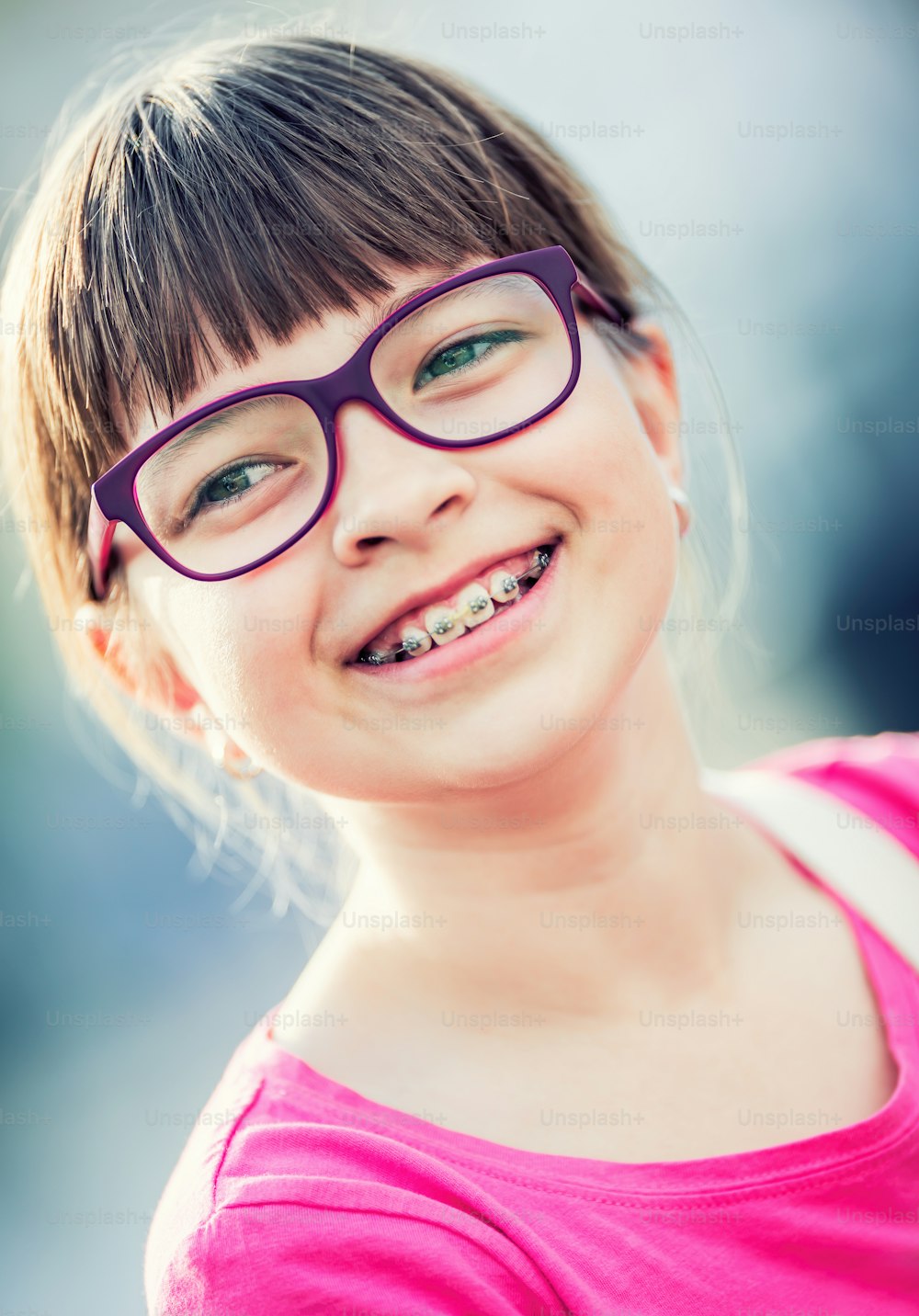 Girl. Teen. Pre teen. Girl with glasses. Girl with teeth braces. Young cute caucasian blond girl wearing teeth braces and glasses.