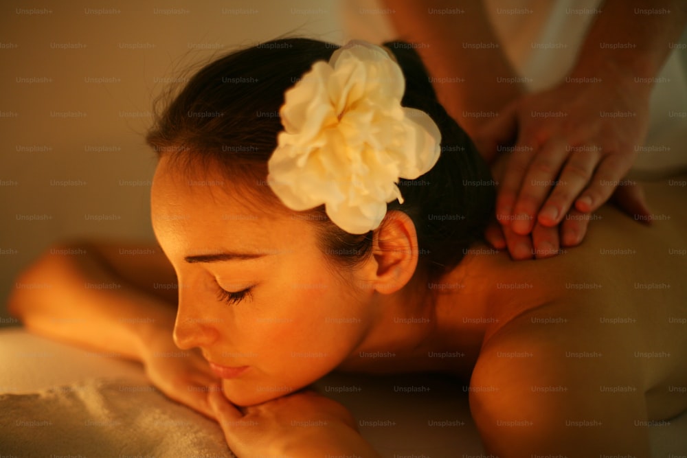 Woman during a massage treatment in spa.