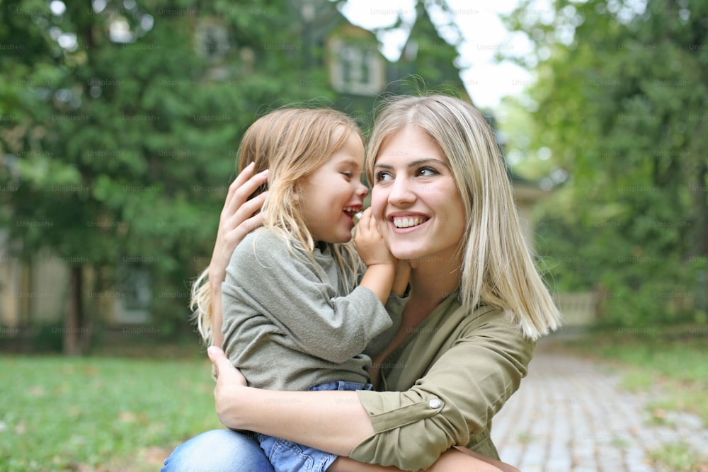 Daughter whispering into her mother.