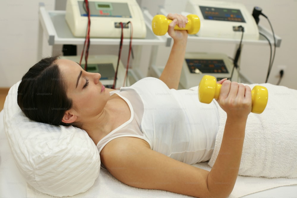 Brunette woman on physical therapy.