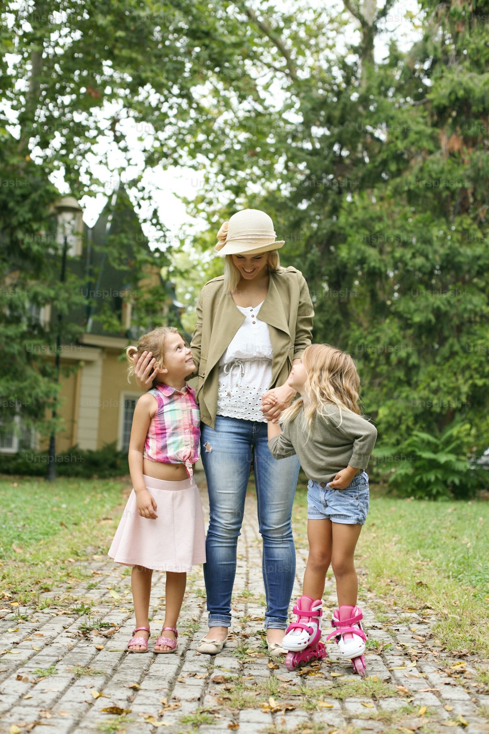 Mother walking and communicate with her two little daughter.