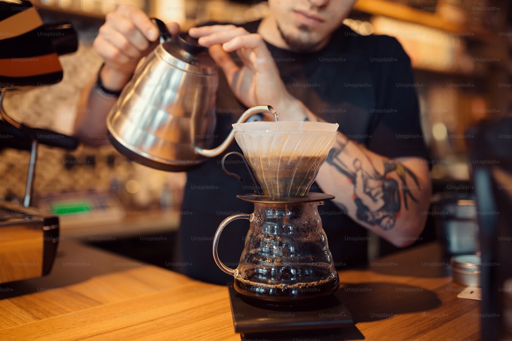 Premium AI Image  Cafe Barista hand making coffee with ground coffee  manually using tamper with coffee in cafe bar