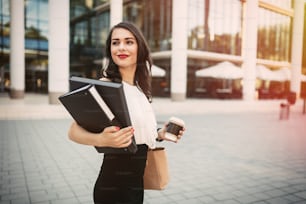 Businesswoman going to work with coffee in hand