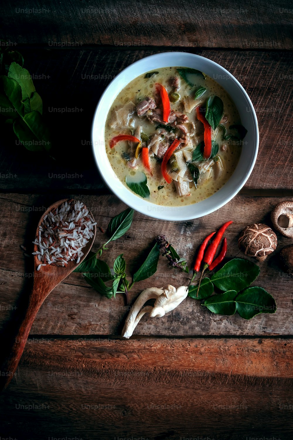 Thai chicken green curry with old wooden background