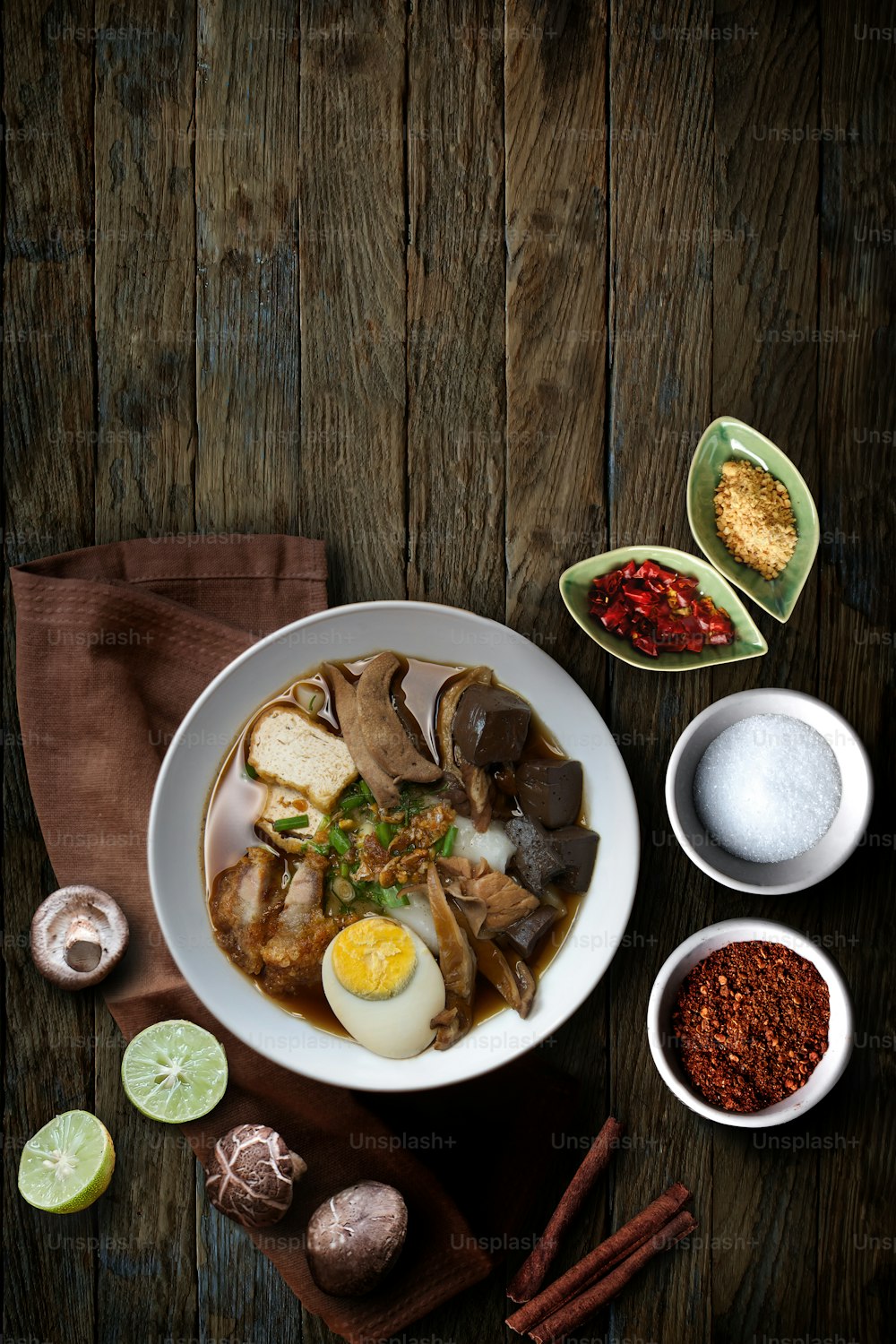 Paste of rice flour with pork, Chinese roll noodle soup over wooden table.