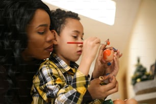 African American woman with her son prepare for Easter