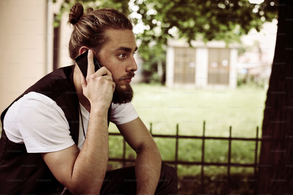 Business man on smart phone in the park.