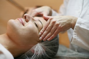 Woman having her face massaged.