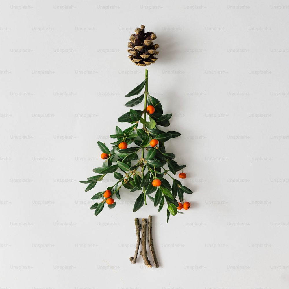 Christmas tree made of leaves and berries. Flat lay. Holiday concept.