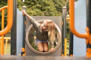 Little girl is climbing at the playground