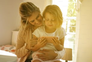 Little girl spending time with her mother at home.