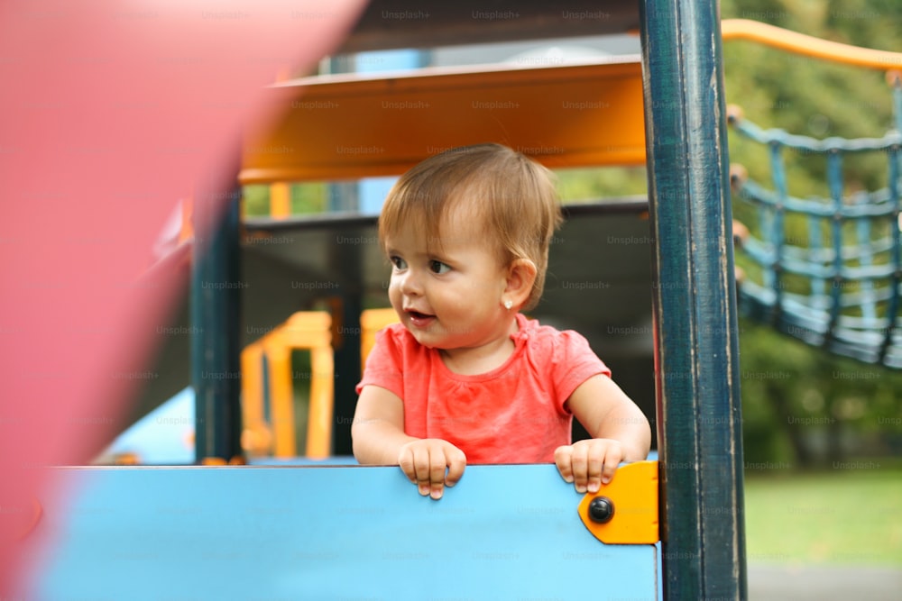 Cute baby girl playing in the backyard.