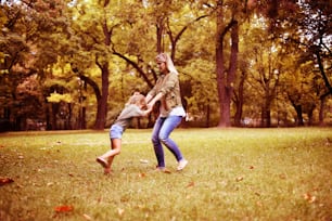 Mother and daughter spending time on the meadow and having fun.