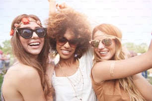 Three of girls spending time togheter in festival