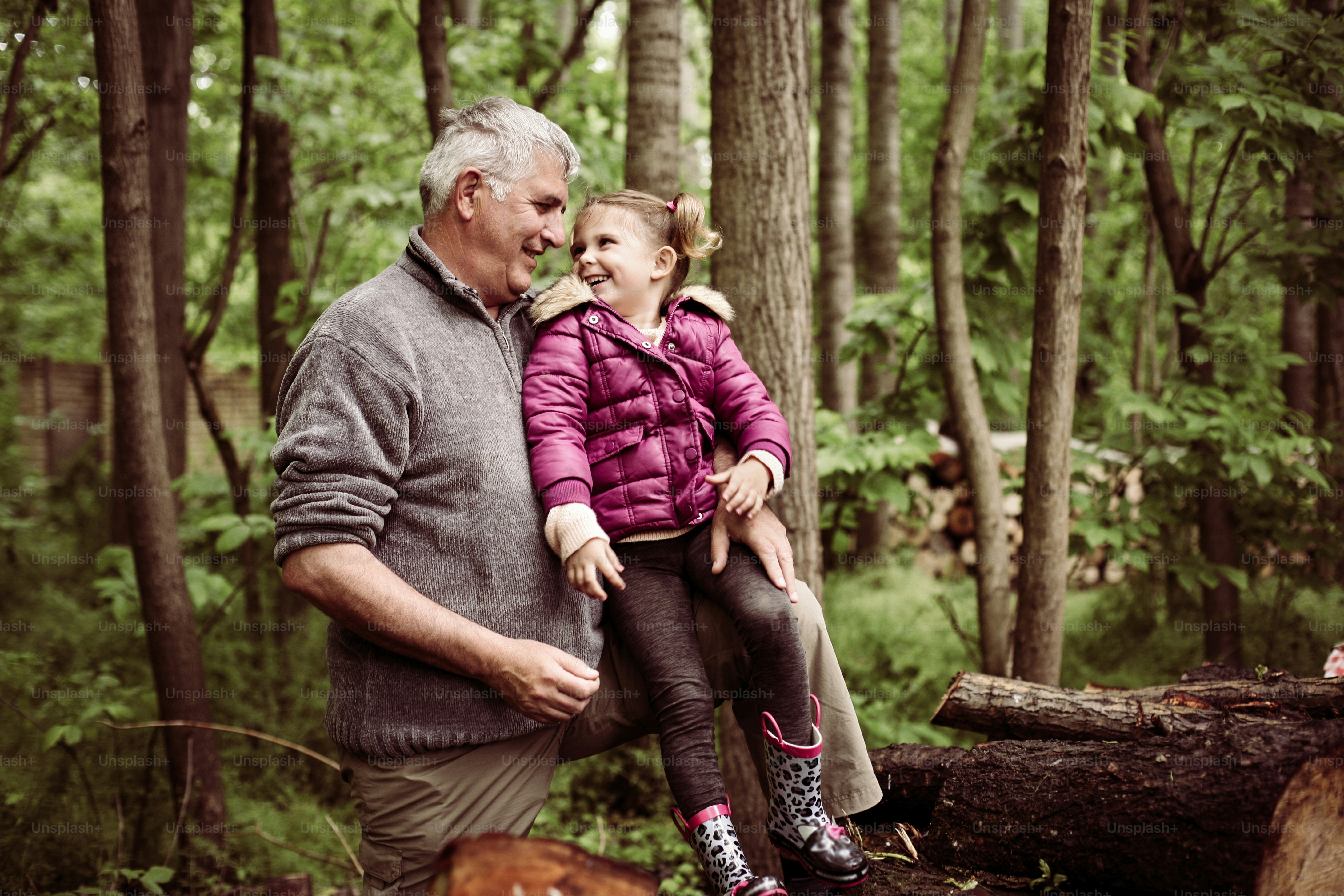 Happy kid with grandfather in the park.