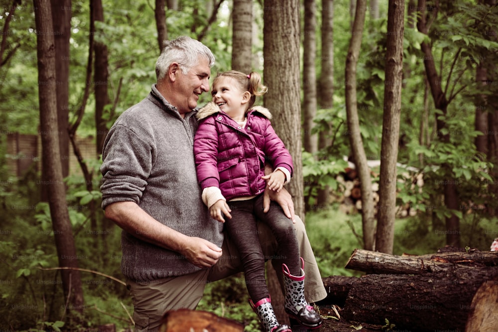 Happy kid with grandfather in the park.