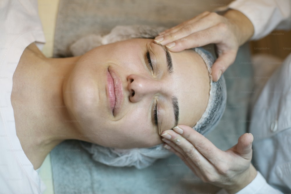 Woman having her face massaged.