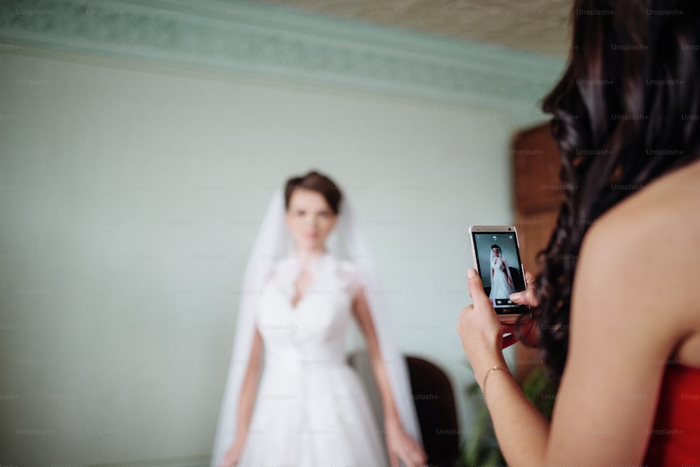 Image of a woman who takes a photo of the bride