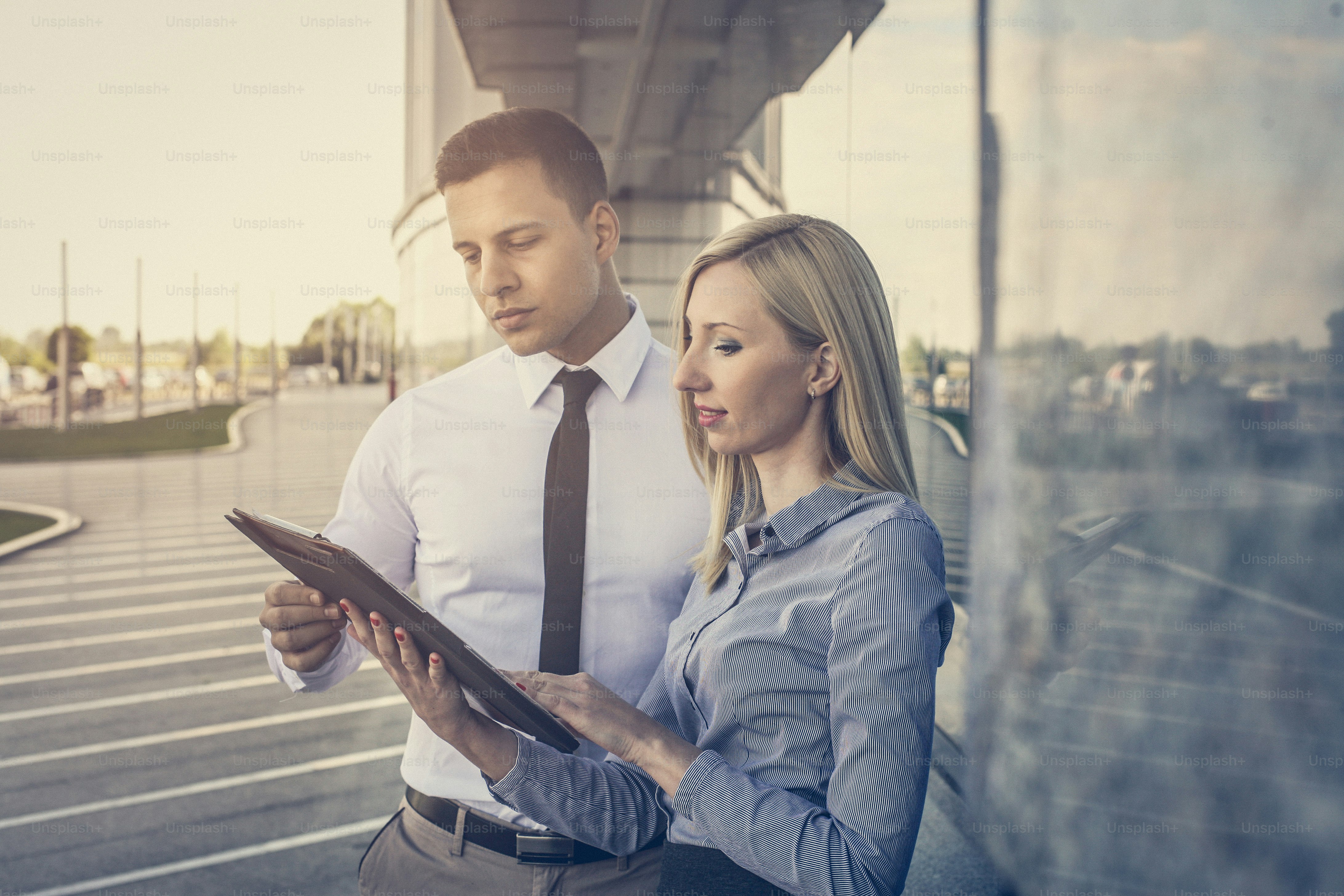 Two colleagues in the work check  the plan.