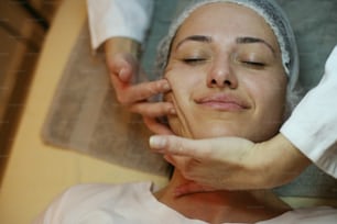 Woman having her face massaged.