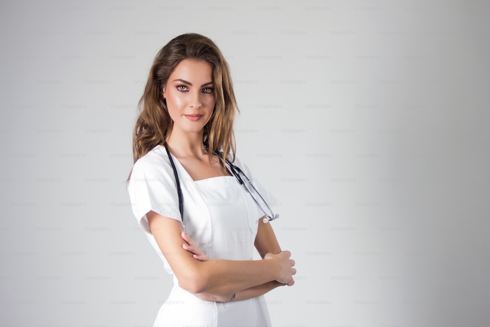 Female doctor standing with her arms crossed and smiling.