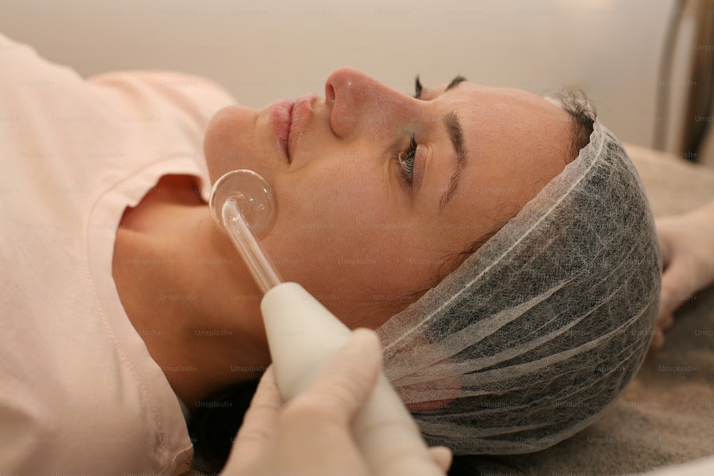 Woman having disinfection on face in beauty salon.