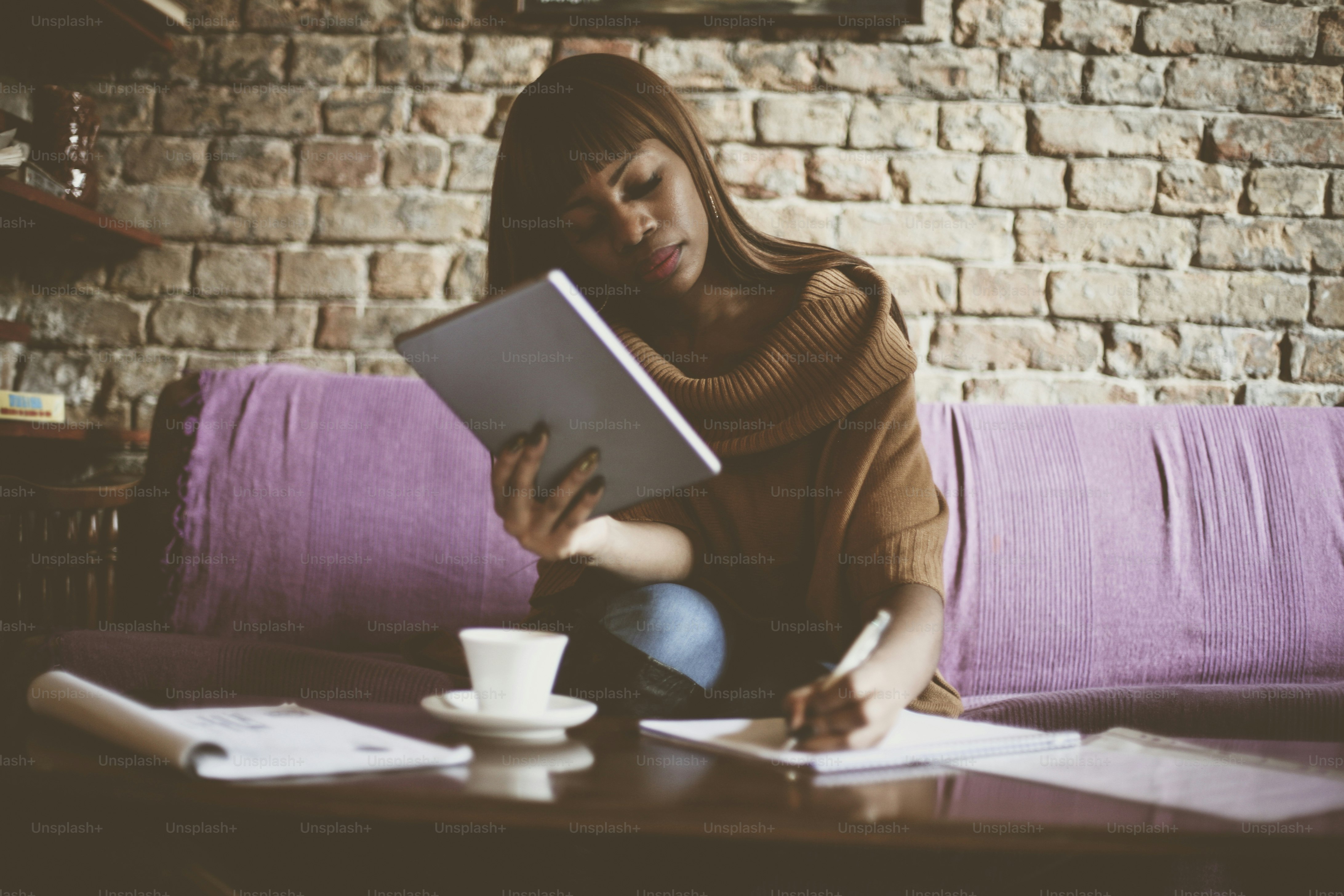African American woman calculating her bills.