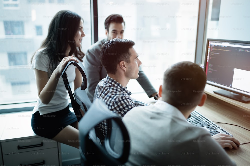 Group of business people and software developers working as a team in office