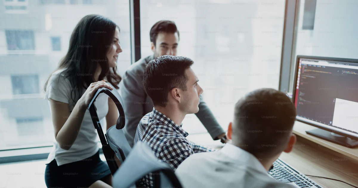 Developer Teamwork Group of business people and software developers working as a team in ...