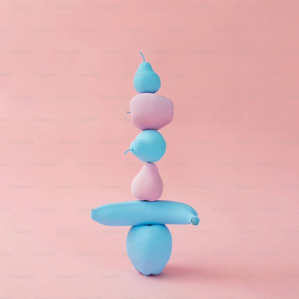 Stacked painted pink and blue fruits. Minimal concept.
