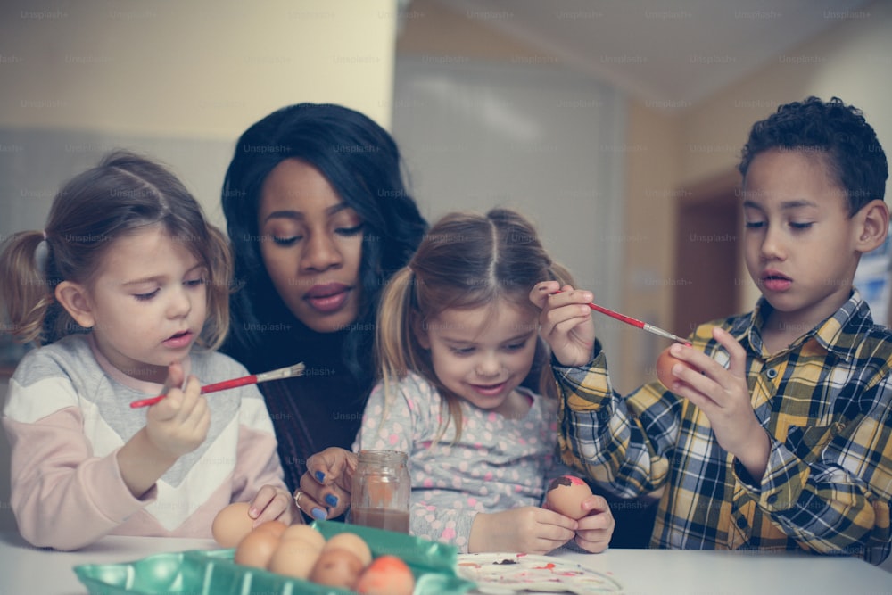 African American woman with three child prepare for Easter.