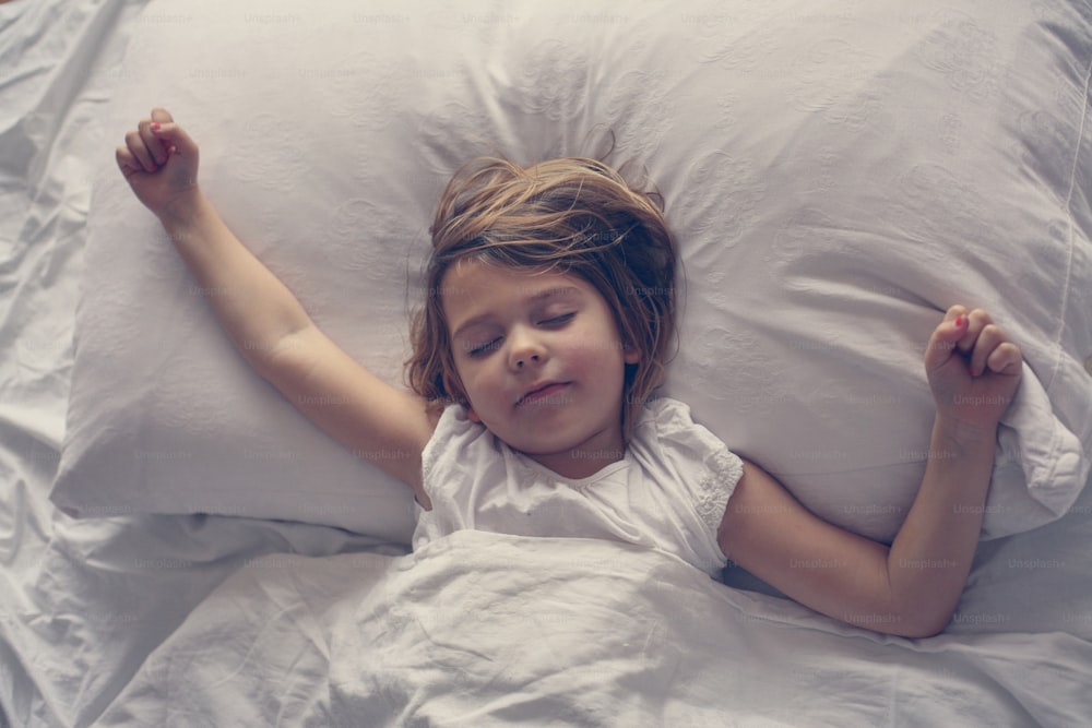 Above view of little girl in bed.